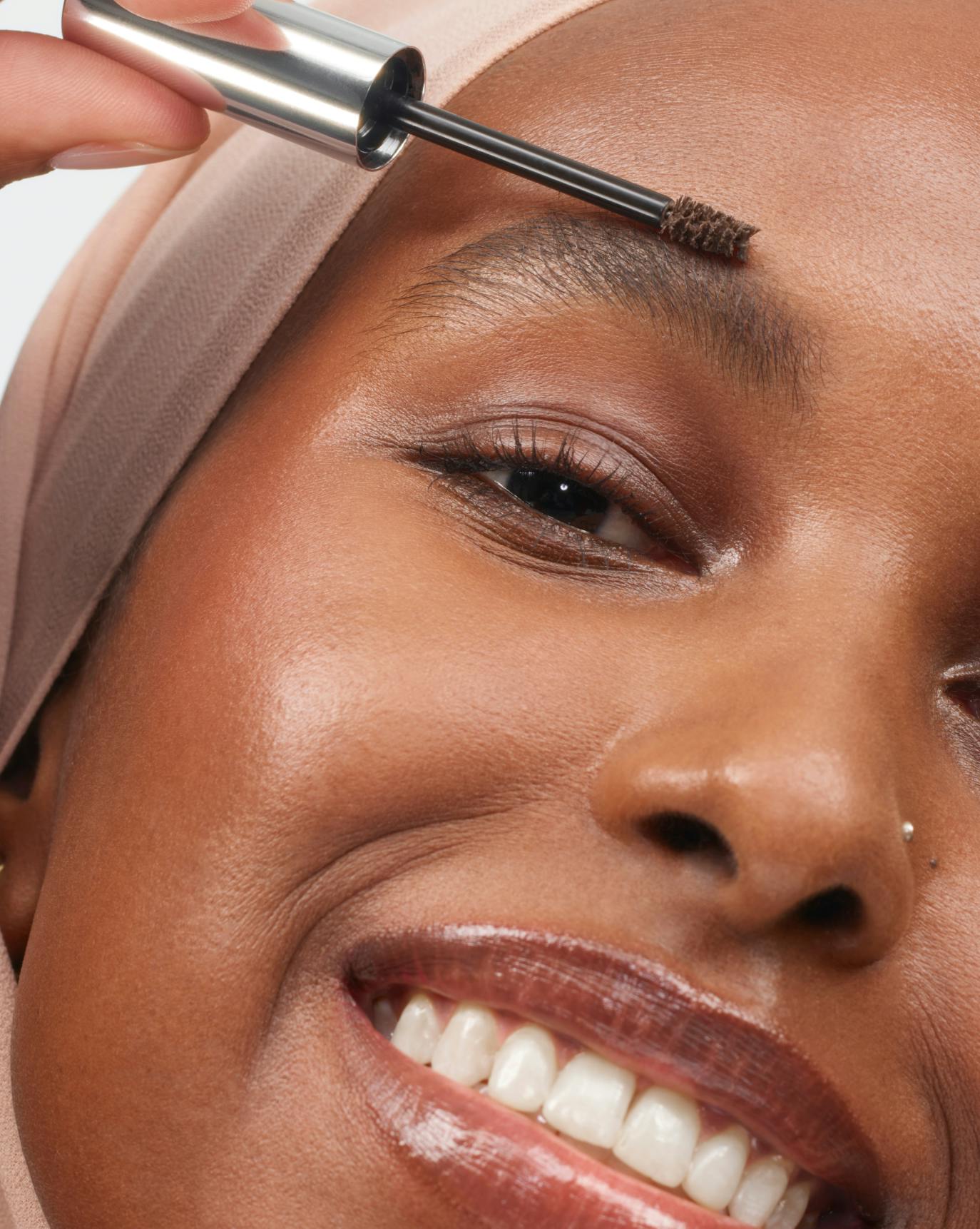 Nasra wears Boy Brow in Dark Brown.